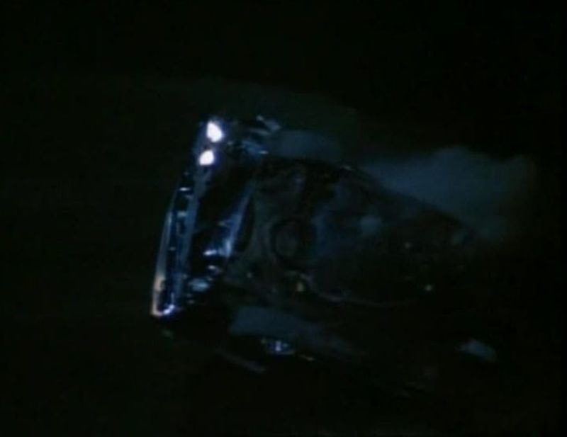 Phantasm Cuda headlights in pitch black — dramatic night approach
