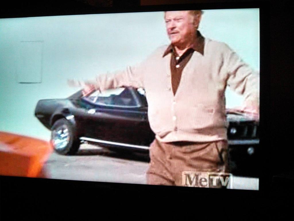 Archival CHiPs episode still showing the James Baker Cuda behind an actor
